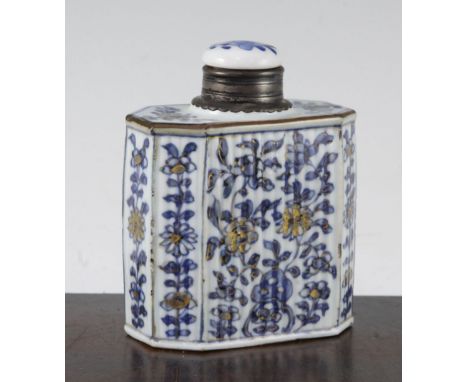 A Chinese export blue and white tea caddy, Kangxi period, of reeded canted rectangular form painted with flowers and rockwork