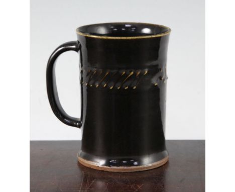 Bernard Leach. A St Ives pottery 'ALE' mug, the slightly waisted cylindrical mug with raised lettering to a slip decorated ba