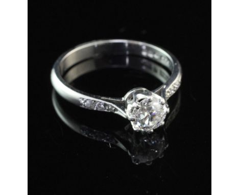A platinum and single stone diamond ring, with diamond set shoulders, the central round cut stone weighing approximately 0.53