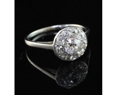A platinum and old cut diamond cluster ring, of circular form, size N.