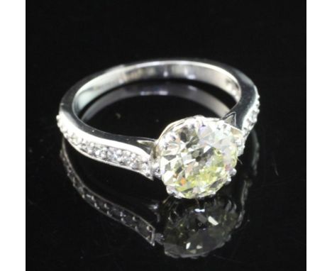 A white gold and single stone diamond ring, with diamond set shoulders, the central stone weighing 2.08ct, size N.