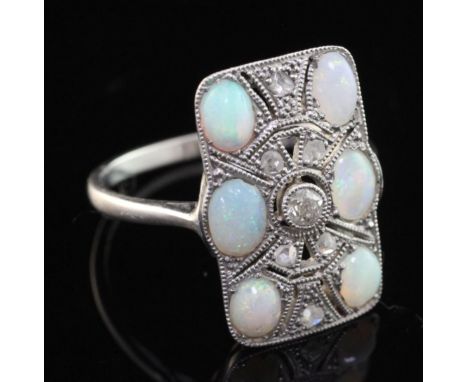 A 1920's platinum, white opal and rose cut diamond set tablet ring, with pierced millegrain setting, size O.