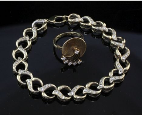 A 9ct gold and diamond dress ring, of reeded disc form, with rotating diamond set spiral fan motif, size L, together with a 9