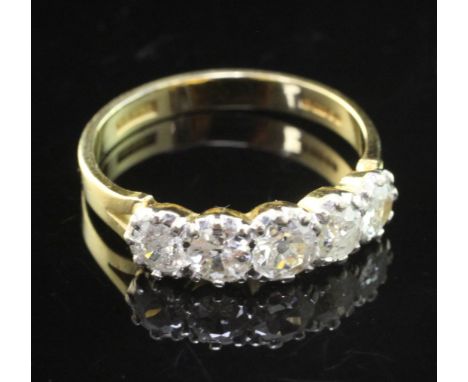 An early 1990's 18ct gold and five stone diamond half hoop ring, set with round cut stones, size P.