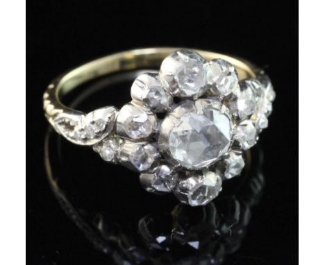 An antique style gold and silver, diamond cluster ring, set with rose cut stones, the central diamond weighing approximately 