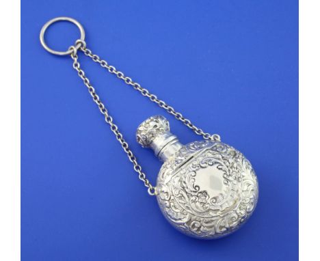 A late Victorian silver combination moon shaped scent flask and compact, embossed with foliate scrolls, with lidded compartme