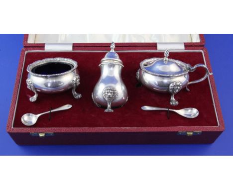 A cased late 1960's silver three piece condiment set by Roberts & Belk, with blue glass liners and two matching condiment spo