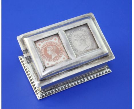 A late Victorian silver twin compartment stamp box by Goldsmiths & Silversmiths Co Ltd, of rectangular form, the slanted lid 