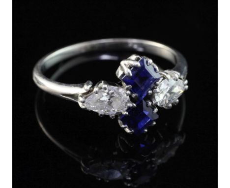 A 1940's white gold, diamond and sapphire ring, set with two square cut sapphires and two teardrop shaped diamonds, size L.