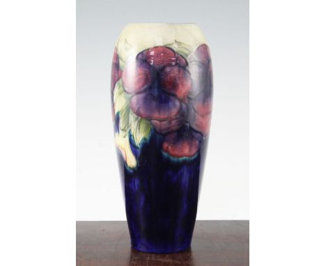 Two William Moorcroft pansy pattern vases, c.1917, the first of tall ovoid form, the second of waisted cylindrical form, both