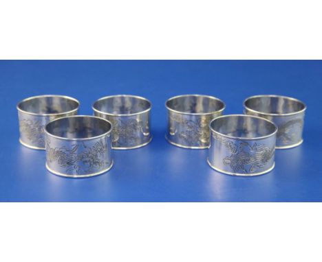 A set of six Chinese? silver napkin rings, each engraved with a dragon, unmarked, 3.5 oz.