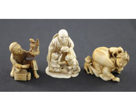 A Japanese ivory netsuke and two similar okimono, Meiji period, the netsuke carved as an elderly man holding a guinea pig? wi