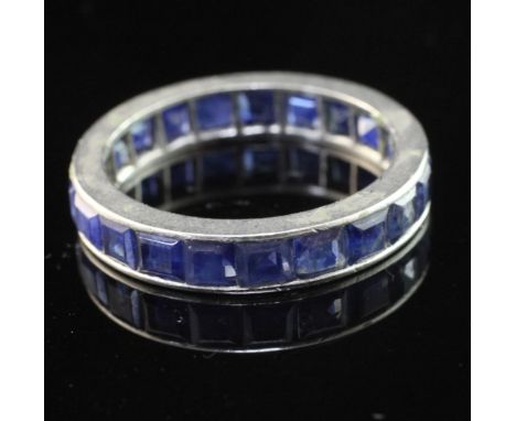 A platinum and sapphire full eternity ring, set with square cut stones, size L.