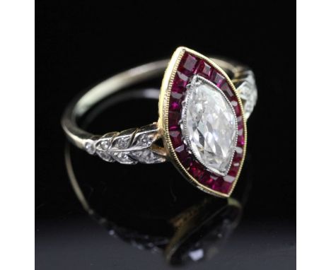 An attractive mid 20th century? gold, ruby and diamond ring, the central marquise cut diamond weighing in excess of 1.00ct, w