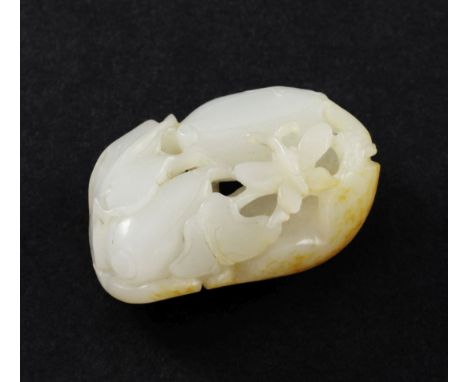 A Chinese white and russet skin jade melon carving, 19th century, carved in high relief and openwork with a butterfly, bitter