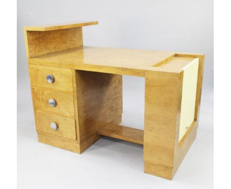 An unusual Art Deco burr maple writing desk, the top with a raised single end shelf above three drawers, with circular chrome