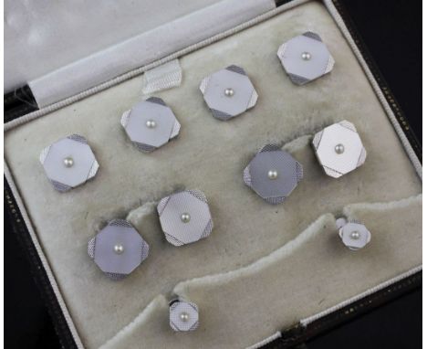 A 1920's 9ct white gold, mother of pearl and split pearl set eight piece dress stud set, in Z. Barraclough & Sons Ltd box.