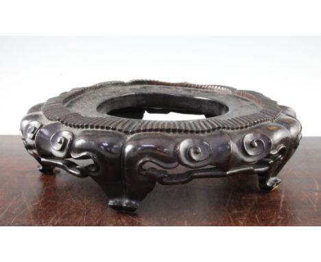 A large Chinese rosewood stand, late 19th / early 20th century, the lobed border carved and pierced with ruyi heads, on five 