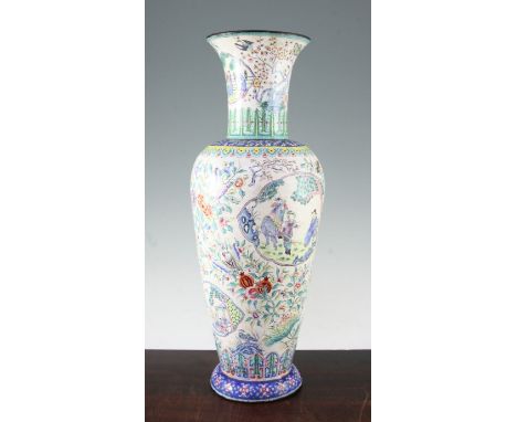 A tall Chinese Canton enamel baluster vase, late 19th / early 20th century, painted with reserves of sages in a garden and th