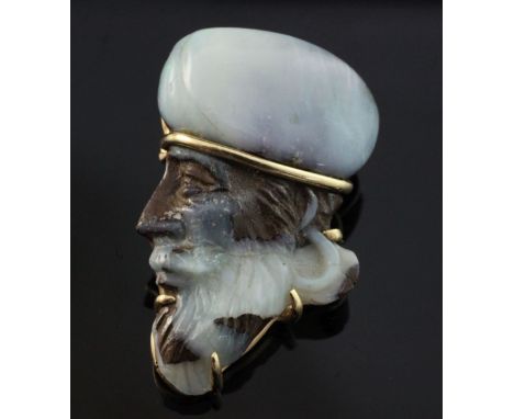 A 20th century gold mounted white opal pendant brooch modelled as the head of a Middle Eastern gentleman to dexter, approx. 1