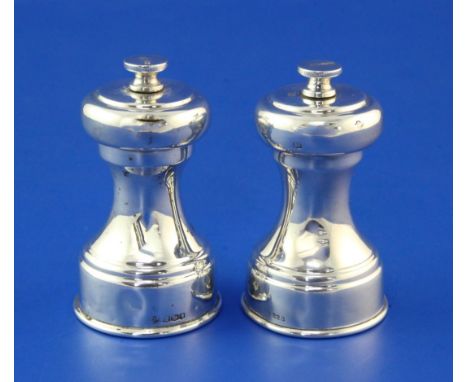 A pair of 1930's silver pepper mills by William Hutton & Sons Ltd, of waisted form, Sheffield, 1936, 3in.