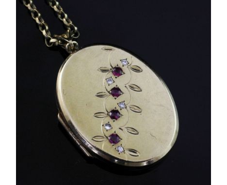 An early 20th century 9ct gold, ruby and diamond set oval locket, on a 9ct gold chain, gross weight 20 grams, locket 1.5in.