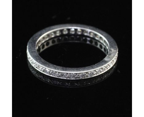 A modern platinum and diamond full eternity ring, set with thirty two round cut stones, size J.