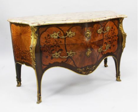 A Louis XV style marble topped bombe shaped commode, decorated all over with floral marquetry inlay and radiating veneers, wi