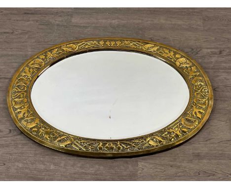 ARTS &amp; CRAFTS BRASS FRAMED OVAL WALL MIRROR,embossed with stylised foliage, bevelled plate, 76.5cm x 52cm