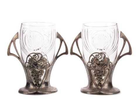 PAIR OF ART NOUVEAU PEWTER AND CUT GLASS VASES BY WMF,the glass inserts cut with geometric designs, the pewter with twin-hand