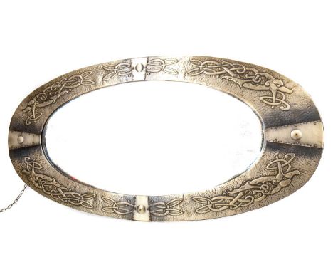 EARLY 20TH CENTURY ARTS &amp; CRAFTS SCOTTISH SCHOOL WALL MIRROR,the hammered metal frame embossed with Celtic knots and styl