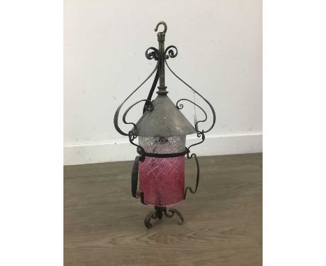 ARTS AND CRAFTS HALL LANTERN,with graduated textured clear and cranberry glass shade, in wrought iron mount, 49cm long