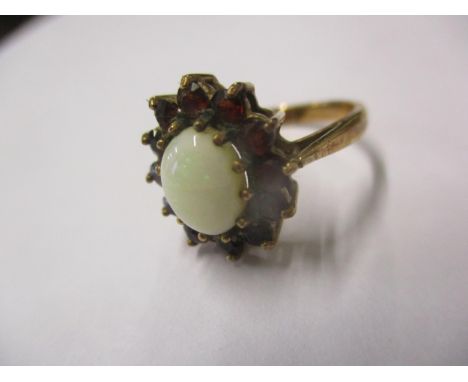 A 9ct gold opal and garnet ring size J, total weight 2.9g Location: Cab 