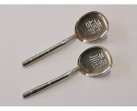 A pair of Chinese silver spoons in the form of fans with bamboo handles, stamped sterling 950, Location: CAB 