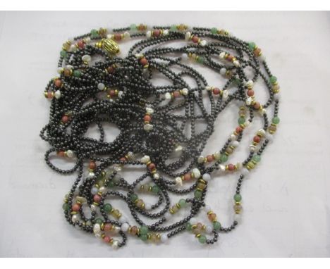 A seven-strand necklace with a gold coloured clasp stamped 750 with tungsten, pearl, gold coloured jade beadsLocation: CAB 