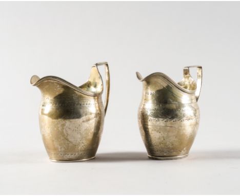 TWO GEORGE III SILVER MILK JUGS (2)Each of helmet shaped form, with engraved decoration, London 1801 and London 1800, combine