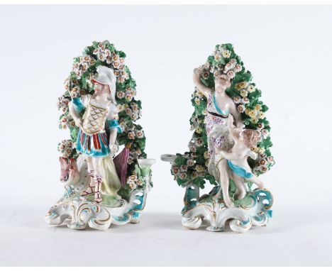 A PAIR OF DERBY PORCELAIN CANDLESTICK FIGURES (2)Circa 1770 Modelled as Mars and Venus and Cupid standing before a flowering 