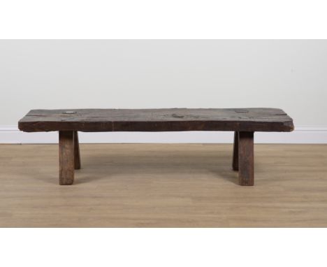 A 19TH CENTURY OAK SLAB TOPPED PIG BENCHOn four staked supports, 183cm wide; 43cm deep