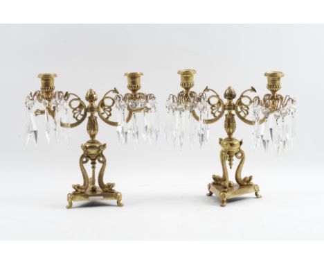 A PAIR OF REGENCY GILT-BRASS TWIN LIGHT CANDELABRA (2)Modern With serpent candle arms hung with faceted glass drops, supporte