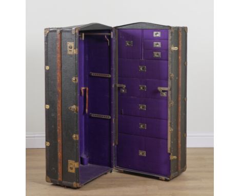 AN EARLY 20TH CENTURY CANVAS TRAVELLING STEAMER TRUNK60cm wide; 54cm deep; 125cm highOld marks and scratches present all over