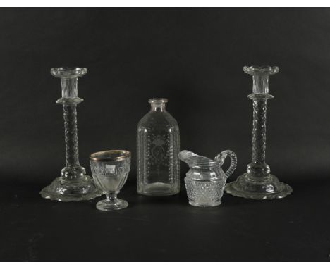 A PAIR OF CUT GLASS CANDLESTICKS (5)Late 18th/19th century Each with a facet cut stem and facet cut petal base, 27cm high; al