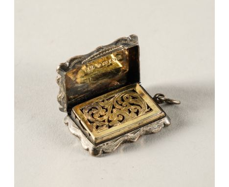 A VICTORIAN SILVER SHAPED RECTANGULAR VINAIGRETTEWith a scroll pierced and engraved grille, the exterior engine turned and in