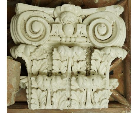 A GROUP OF MOULDED PLASTER ARCHITECTURAL PLAQUES AND ELEMENTS, TOGETHER WITH PAINTED WOOD CORINTHIAN CAPITALS (QTY)The capita