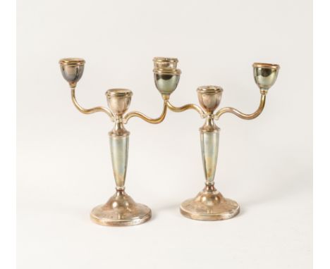 A PAIR OF SILVER THREE LIGHT TABLE CANDELABRAEach having a tapered urn form stem, raised on a domed circular foot, Birmingham