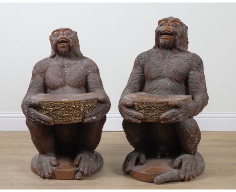 W. WINTEN BALI; TWO PARCEL GILT HARDWOOD SEATS, RELIEF CARVED AS MONKEYS HOLDING A DRUM (2)The larger 57cm wide; 97cm high, t