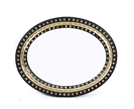 A 19TH CENTURY IRISH EBONISED OVAL MIRRORWith faceted glass bead decoration, 72cm wide; 57.5cm highTwo small splits present t