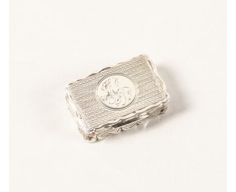 A LATE VICTORIAN SILVER VINAIGRETTEOf shaped rectangular form, with a scroll pierced and engraved grille, the exterior engine