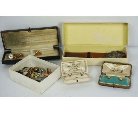An assortment of yellow metal, mother of pearl and related studs, with three badges and similar items (a lot)