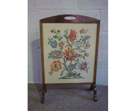An early 20th century fire screen, the rectangular tapestry panel decorated with a spay of mixed flowers, 83cm high