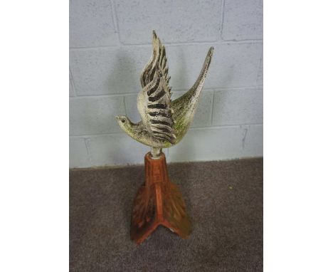 A decorative terracotta roof tile with bird surmount, the white painted bird with wings outspread, 74cm high